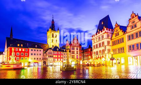 Trier, Germany: Sunset view of the Hauptmarkt, the Main Market. Medieval center of Trier surrounded by historic buildings and St. Gangolf church Stock Photo