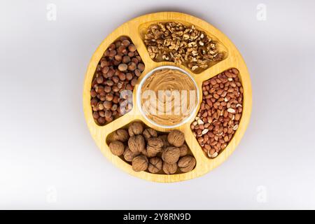 Peanuts, walnuts and hazelnuts in a wooden box with compartments. Three different types of nuts, shelled and shelled, decorative assortment and ready Stock Photo
