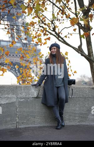Stylish Autumn Woman in Coat and Beret by Eiffel Tower and Avenue De New York Stock Photo
