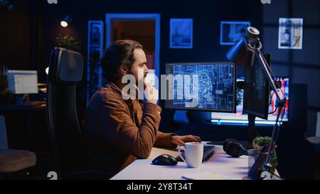 Software developer writes code on multimonitor setup PC to visualize artificial intelligence neural networks. Teleworking IT employee runs AI script on computer from home office, camera B Stock Photo