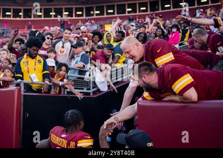 Landover, United States. 06th Oct, 2024. Washington Commanders running back Brian Robinson Jr. (8) shakes hands with fans after a game against the Cleveland Browns at Northwest Stadium in Landover, Maryland on Sunday, October 6, 2024. The Commanders defeated the Browns 34-14. Photo by Bonnie Cash/UPI Credit: UPI/Alamy Live News Stock Photo