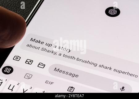Close-up of a smartphone displaying a text prompt in ChatGPT, requesting to create a story. Stafford, United Kingdom, October 6, 2024. Stock Photo