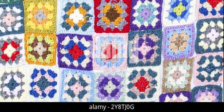 Multi colored blanket in wool, geometric background, retro decorative pattern Stock Photo