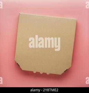 Pizza closed carton box on uniform pink background flat lay mockup with copyspace Stock Photo