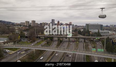 The cable car is full of riders exploring Portland via aerial trensportation Stock Photo