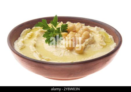 Hummus made of cooked, mashed chickpeas topped with beans and green coriander leaves isolated on white background. Clipping path added Stock Photo