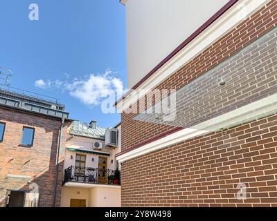 renovated old buildings in downtown against blue sky background at bright sunny day. Stock Photo