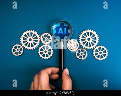 AI searching management tools, development technology assistance service support concept. AI mechanic gear icon in magnifying glass lens in human hand Stock Photo