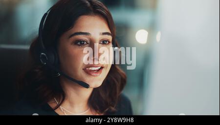 Customer service, computer and woman in office at night for international technical support consultation online. Headset, tech and call center agent Stock Photo