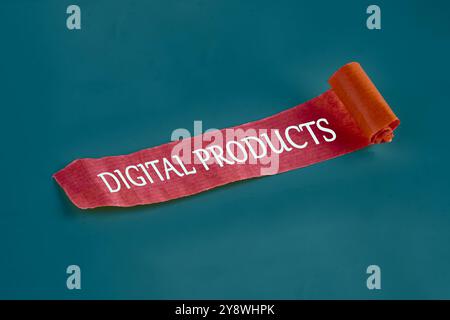 The concept of the info business. The text of DIGITAL PRODUCTS is written on a piece of unfolded red note, paper on a dark background. Stock Photo