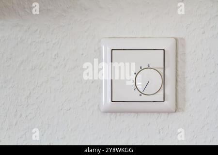 Modern White Thermostat on White Wall  Stock Photo