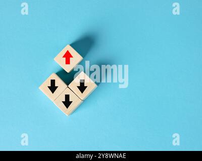 Red arrow pointing in opposite direction of black arrows, showing the concept of being different and going against the flow. Stock Photo