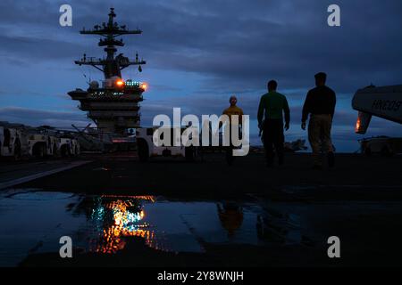 PACIFIC OCEAN (Oct. 2, 2024) The U.S. Navy Sailors transit the flight deck aboard the Nimitz-class aircraft carrier USS Theodore Roosevelt (CVN 71), O Stock Photo