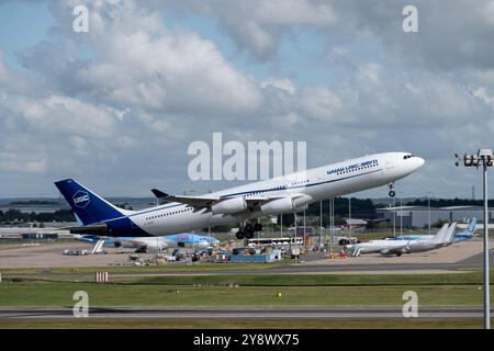 Universal Sky Carrier Airbus A340-313 taking off at Birmingham Airport, UK (D-AUSC) Stock Photo