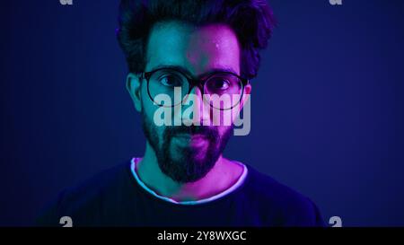 Close up portrait Arabian Indian man guy male programmer coder put on glasses 3d dimension focus gesture insight good eye sight vision focused view Stock Photo