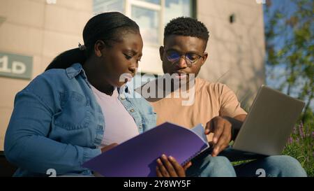 Two African American friends students discuss talking education project high school learning study together pupils gen z classmates university college Stock Photo
