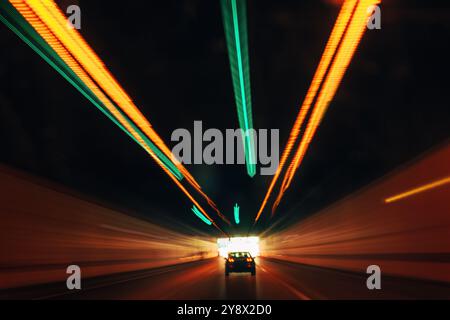 Long exposure photo of car driving through highway tunnel as abstract background Stock Photo