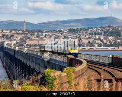 Dundee city, train crosses the Tay Rail Bridge with the city of Dundee in the background, Scotland Stock Photo