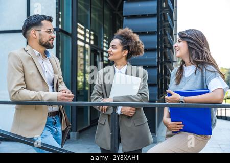 Group of young businesspeople stock market and exchange experts, leaders in modern science, finance and economy standing outside of office building. S Stock Photo