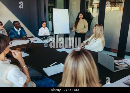 Students engaged in teamwork and discussion, sharing ideas in a collaborative meeting. The atmosphere promotes learning and diversity. Stock Photo