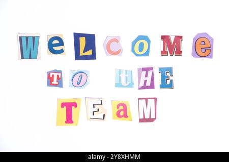 Welcome symbol. Concept words Welcome To The Team isolated on clean white background in fun cut out newspaper style typescript. Business, motivational Stock Photo