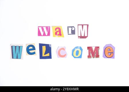 Welcome symbol. Concept words Warm Welcome isolated on clean white background in fun cut out newspaper style typescript. Motivational welcome concept. Stock Photo