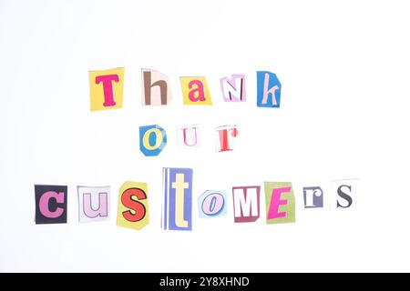 Thank you symbol. Fun cut out newspaper style typescript with words Thank Our Customers. Isolated on clean white background. Stock Photo