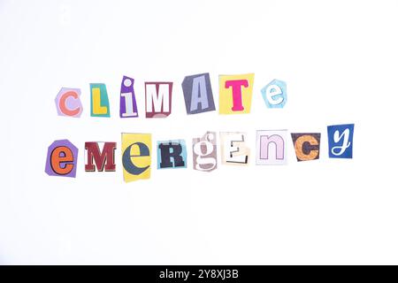 Phrase Climate Emergency spelled in cut out newspaper style typography, isolated on white background. Stock Photo