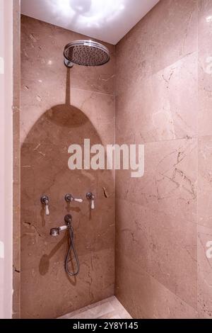 Shower head in marble cubicle in Spanish villa, Mallorca. Stock Photo