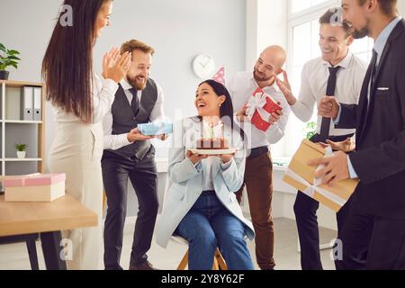 Business people coworkers congratulating their colleague on birthday in office Stock Photo