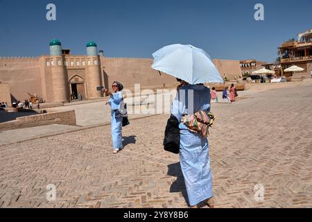 Khiva,Uzbekistan; September,21,2024:two women, both dressed in blue, as they enjoy a walk through the charming streets of Khiva, Uzbekistan. One of th Stock Photo