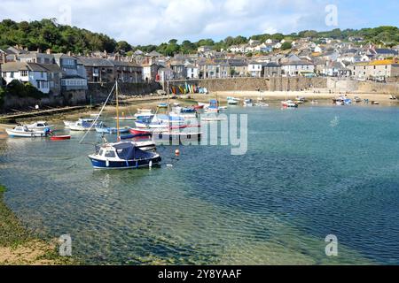 Mousehole fishing village harbour, at low tide, on the shore of Mount's Bay, Cornwall, UK. Stock Photo