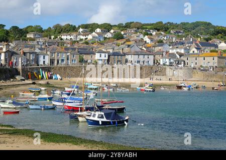 Mousehole fishing village harbour, at low tide, on the shore of Mount's Bay, Cornwall, UK. Stock Photo