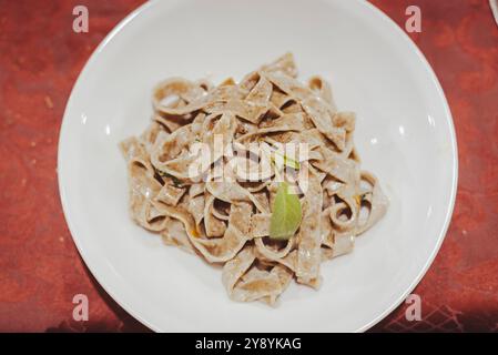 the Tagliatelle, the very popular traditional italian pasta. Here in the classic "butter and sage" (burro e salvia) recipe. Stock Photo