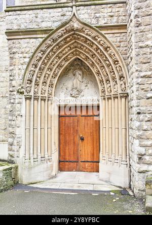 Entrance door to the Catholic christian church of the Immaculate Conception run by the Jesuit priests, Farm Street, Mayfair, London, England. Stock Photo