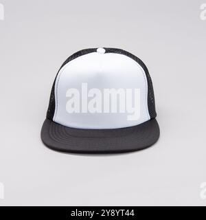 Front view  of Black Mesh Baseball cap with white front on grey background Stock Photo
