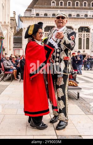 A Pearly King Dances With A London Borough Mayor At The Annual Pearly Kings and Queens Costermongers Harvest Festival, The Guildhall Yard, London, UK. Stock Photo