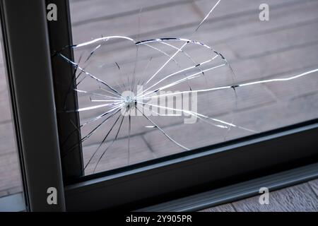 Cracked door glass in close-up. Stock Photo