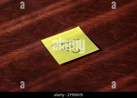 Yellow Sticky Note with Handwritten “Thank You” and Smiley Face – Expressing Gratitude and Appreciation in a Fun, Personal Way, Perfect for Office or Stock Photo