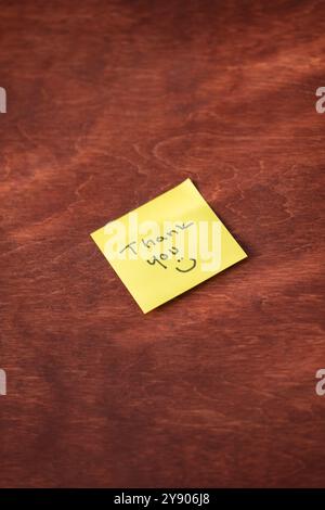 Yellow Sticky Note with Handwritten “Thank You” and Smiley Face – Expressing Gratitude and Appreciation in a Fun, Personal Way, Perfect for Office or Stock Photo