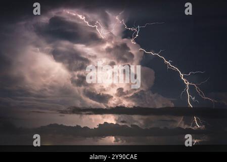 Thunderbolt and lightning on the stormy sea. Stock Photo