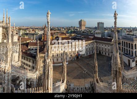 A picture of the Duomo di Milano or Milan Cathedral roof spires and statues overlooking the Palazzo Reale di Milano. Stock Photo