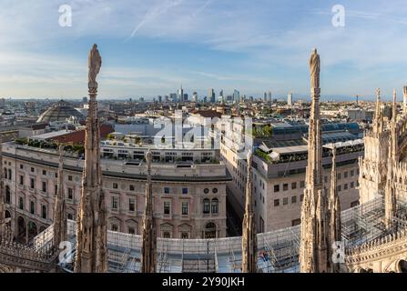 A picture of the Duomo di Milano or Milan Cathedral roof spires and statues overlooking the Porta Nuova business district. Stock Photo