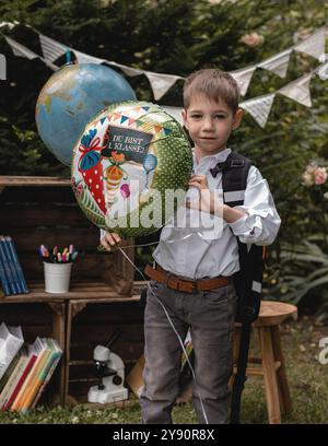 A first-grader. The boy goes to school. A schoolboy holds a balloon in his hands. High quality photo Stock Photo