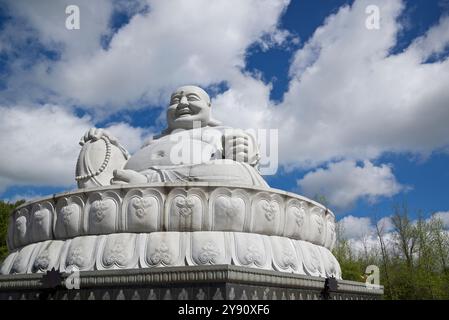 Peterborough, Ontario, Canada / 05-18-2024: The stone statue of Happy Buddha in Peterborough, Ontario, Canada Stock Photo