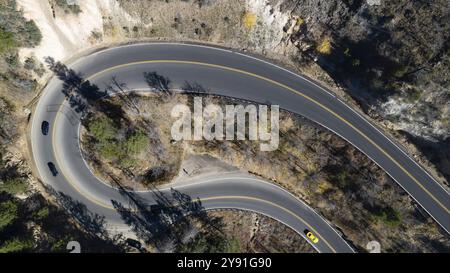 Traffic slows to handle the twists and turns on this curvy two lane highway Stock Photo