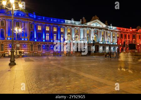 Capitole de Toulouse, the heart of the municipal administration and city hall of Toulouse,  located at Place du Capitole illuminated with french flag Stock Photo