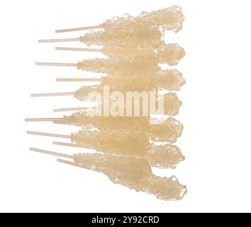 White rock candy sticks on white background, pure crystalized sugar close-up Stock Photo