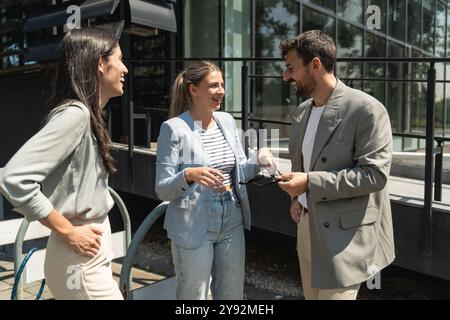 Group of young businesspeople stock market and exchange experts, leaders in modern science, finance and economy standing outside of office building. S Stock Photo