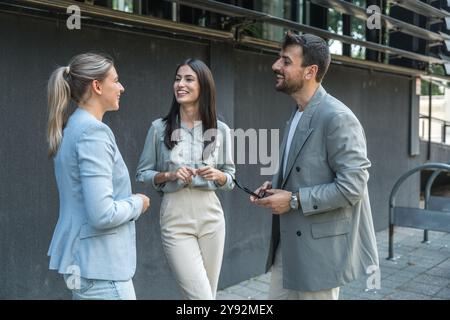 Group of young businesspeople stock market and exchange experts, leaders in modern science, finance and economy standing outside of office building. S Stock Photo